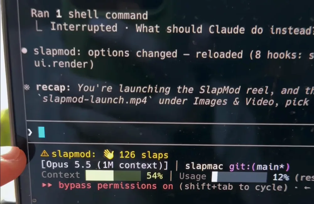 Claude Code interrupted after a slap, with the slapmod slap counter in the status line